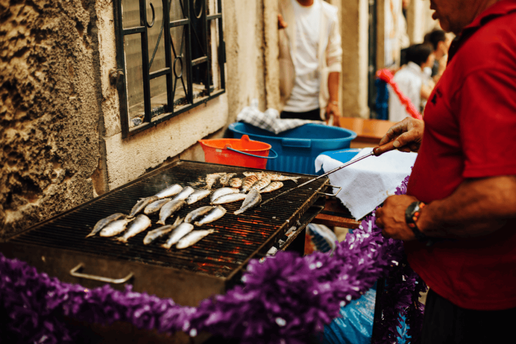 Man grilling sardines at street festival