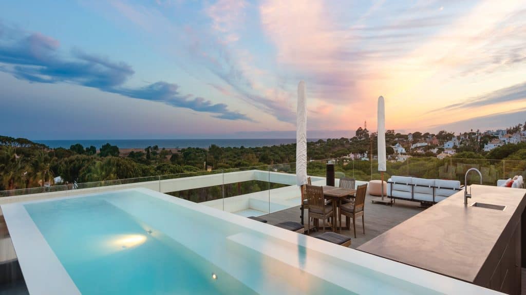Luxury terrace with infinity pool at sunset