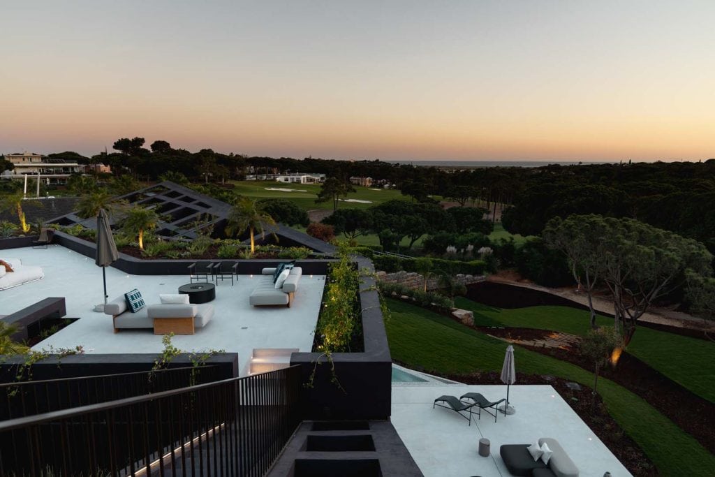 Modern terrace overlooking golf course at sunset