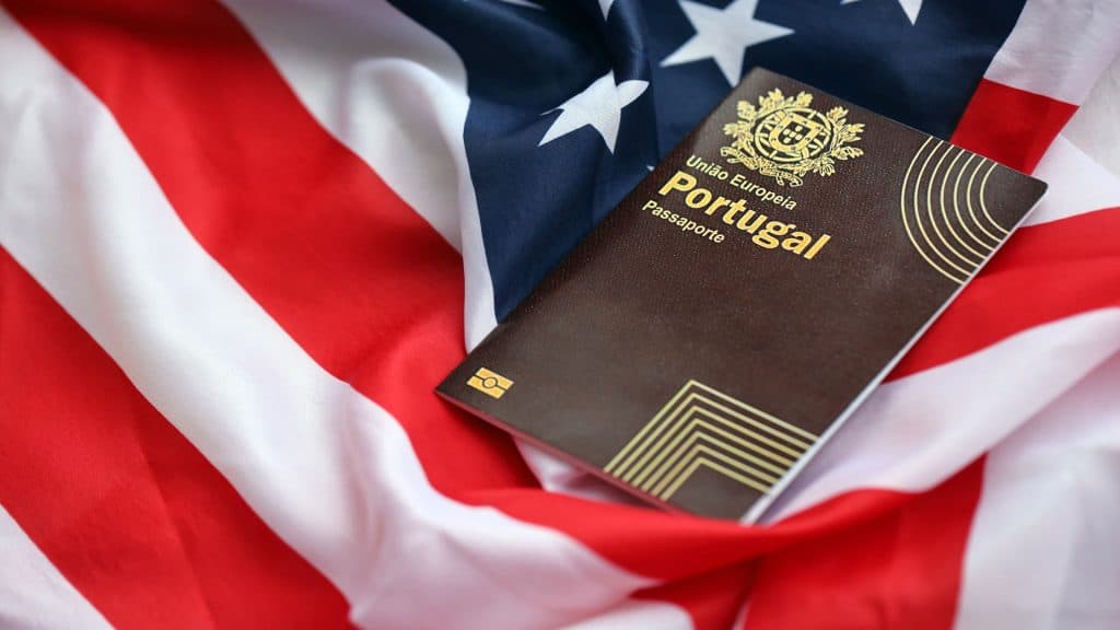 Portuguese passport resting on an American flag