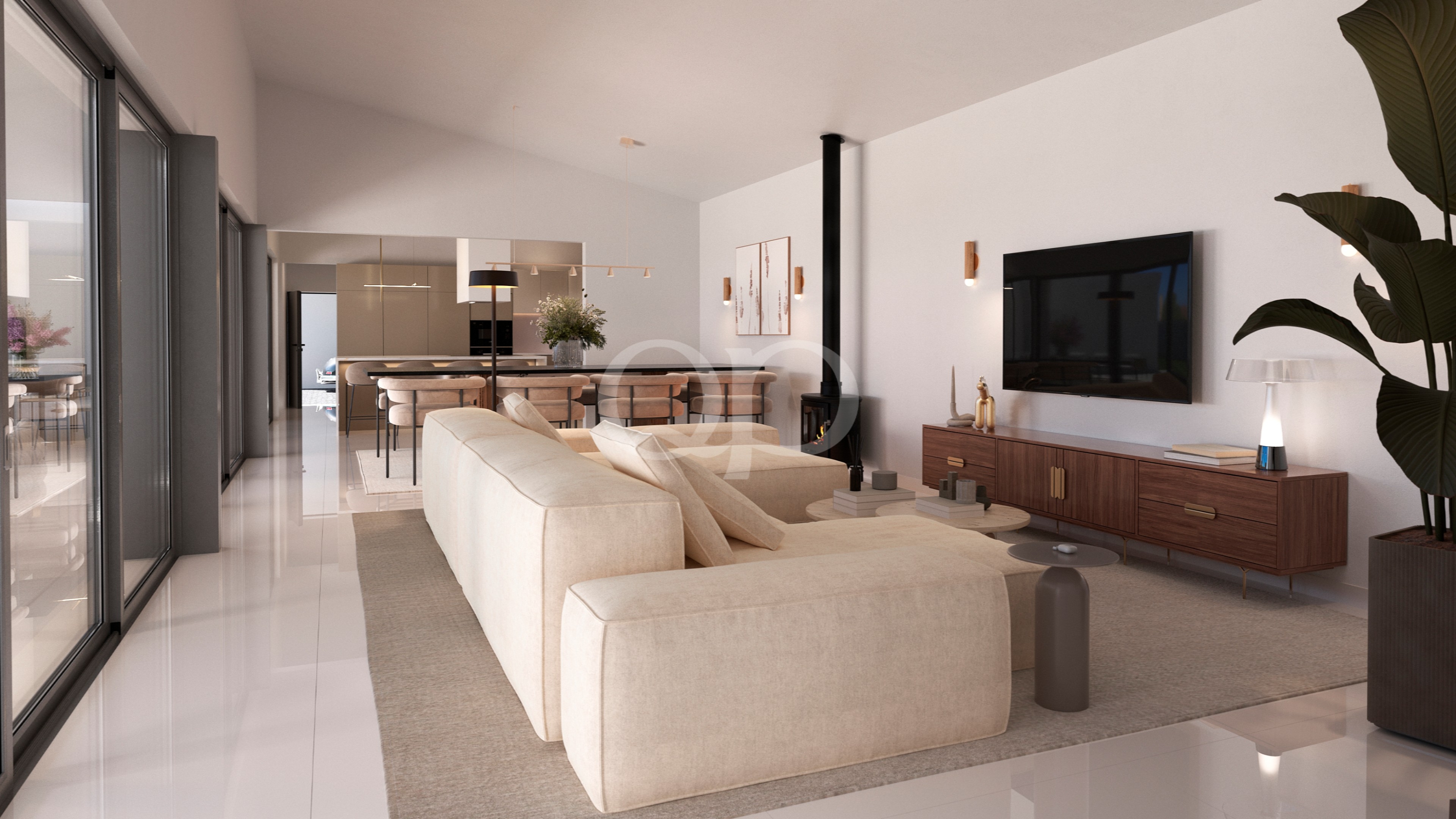 Offener Wohnbereich mit einem beigen Ecksofa, das einem an der Wand montierten Fernseher und einer Konsole aus Holz gegenüberliegt; Glastüren entlang der linken Wand.