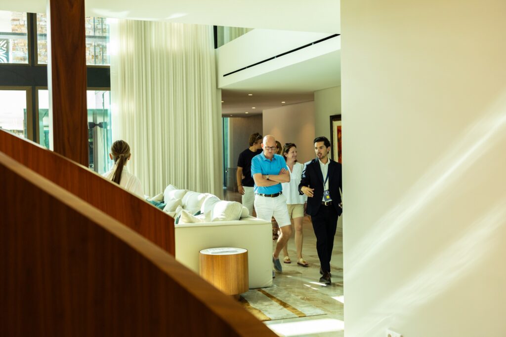 Guests touring a luxury Quinta do Lago home at the QP Summer Classic
