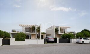 Eingangsbereich einer modernen Villa mit überdachtem Parkplatz und zeitgenössischer Architektur