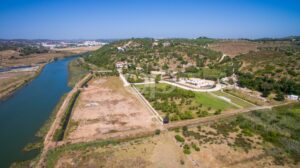 Aerial view across expansive estate grounds towards the nearby coastline