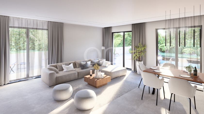 Wohnzimmer mit raumhohen Fenstern und direktem Zugang zur Terrasse