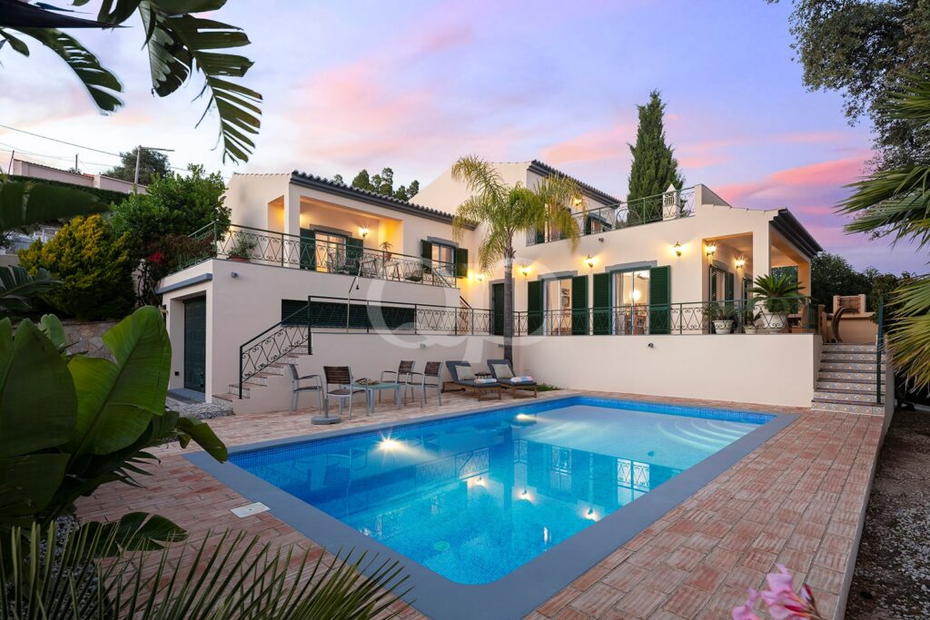 Villa exterior with private swimming pool and illuminated terrace