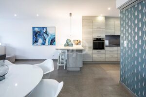 Open plan kitchen and dining area with integrated appliances