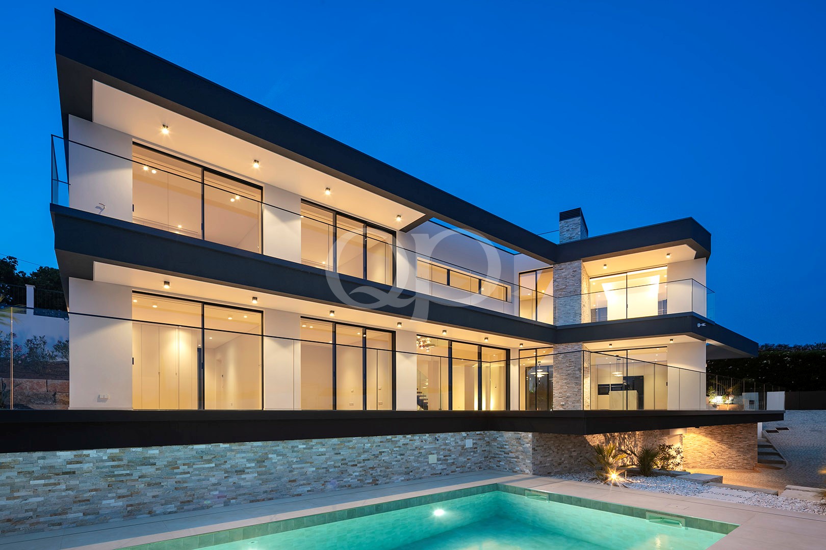 Contemporary villa with floor-to-ceiling windows and abundant lighting