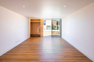 Bright living area with wood flooring and terrace access