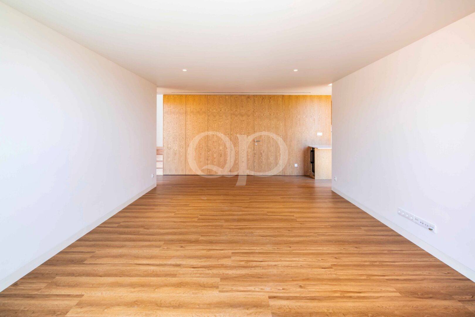 Open plan living and dining area with wood flooring