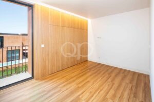 Bedroom with built in wardrobes and wood flooring