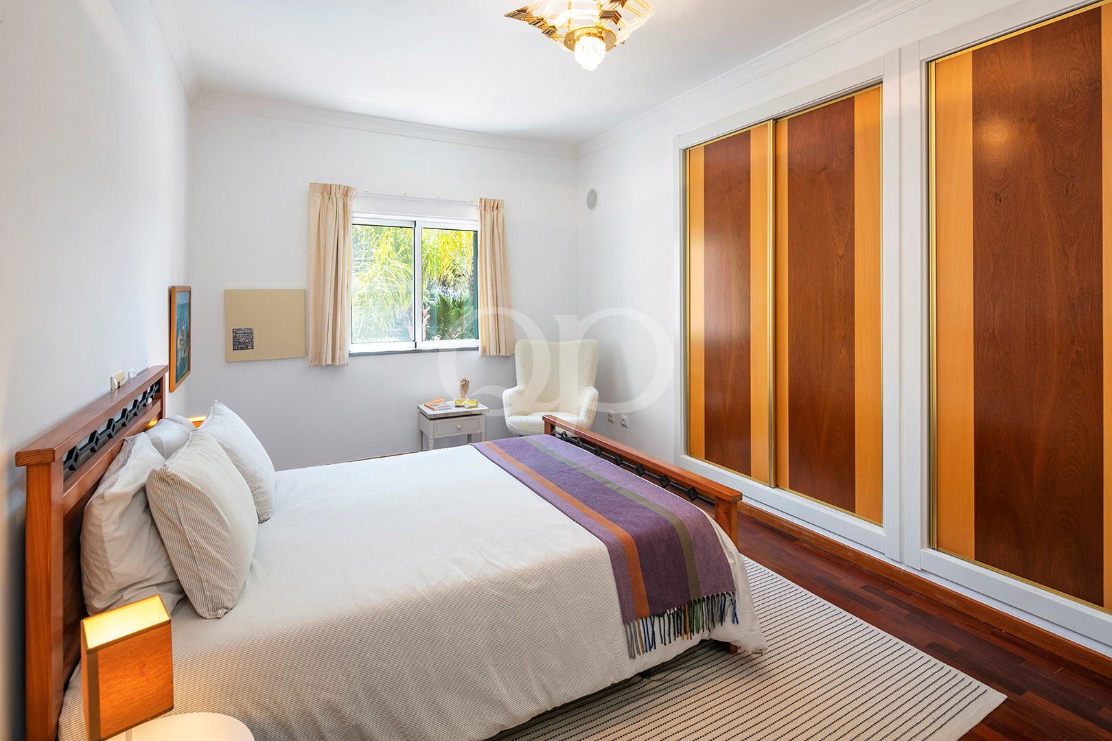 Bedroom with fitted wardrobes and garden views