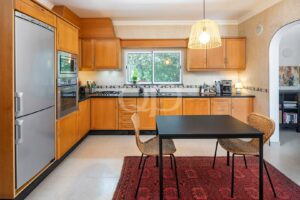 Kitchen with wooden cabinetry, breakfast area and garden views