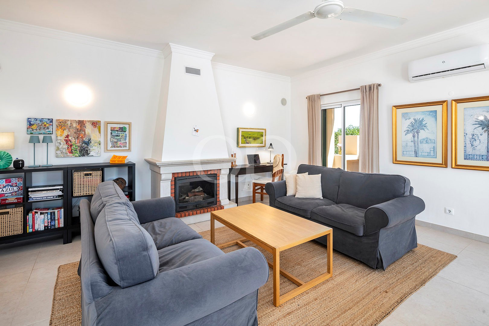 Living room with fireplace and terrace access