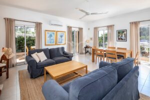 Living and dining room with fireplace and garden access