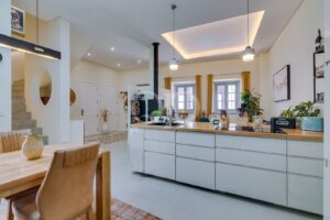 Contemporary kitchen with island, pendant lighting and traditional windows