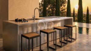 Outdoor stainless steel kitchen island with grill and sink, four wooden-bar stools, by a pool at sunset