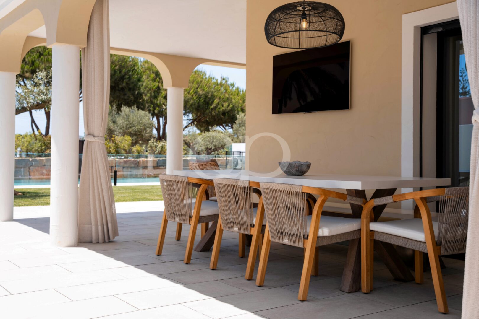 Covered outdoor dining area overlooking the private swimming pool