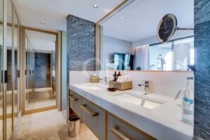 Contemporary bathroom with double vanity, large mirror and stone finishes
