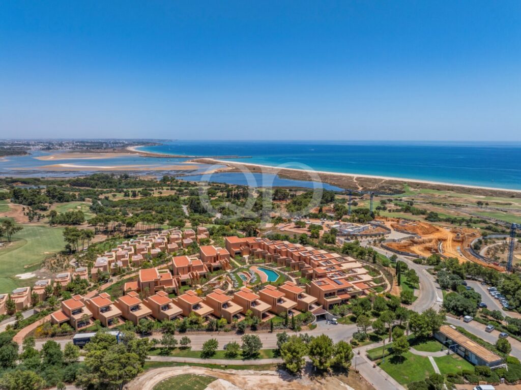 Aerial view of coastal development with beach and ocean beyond