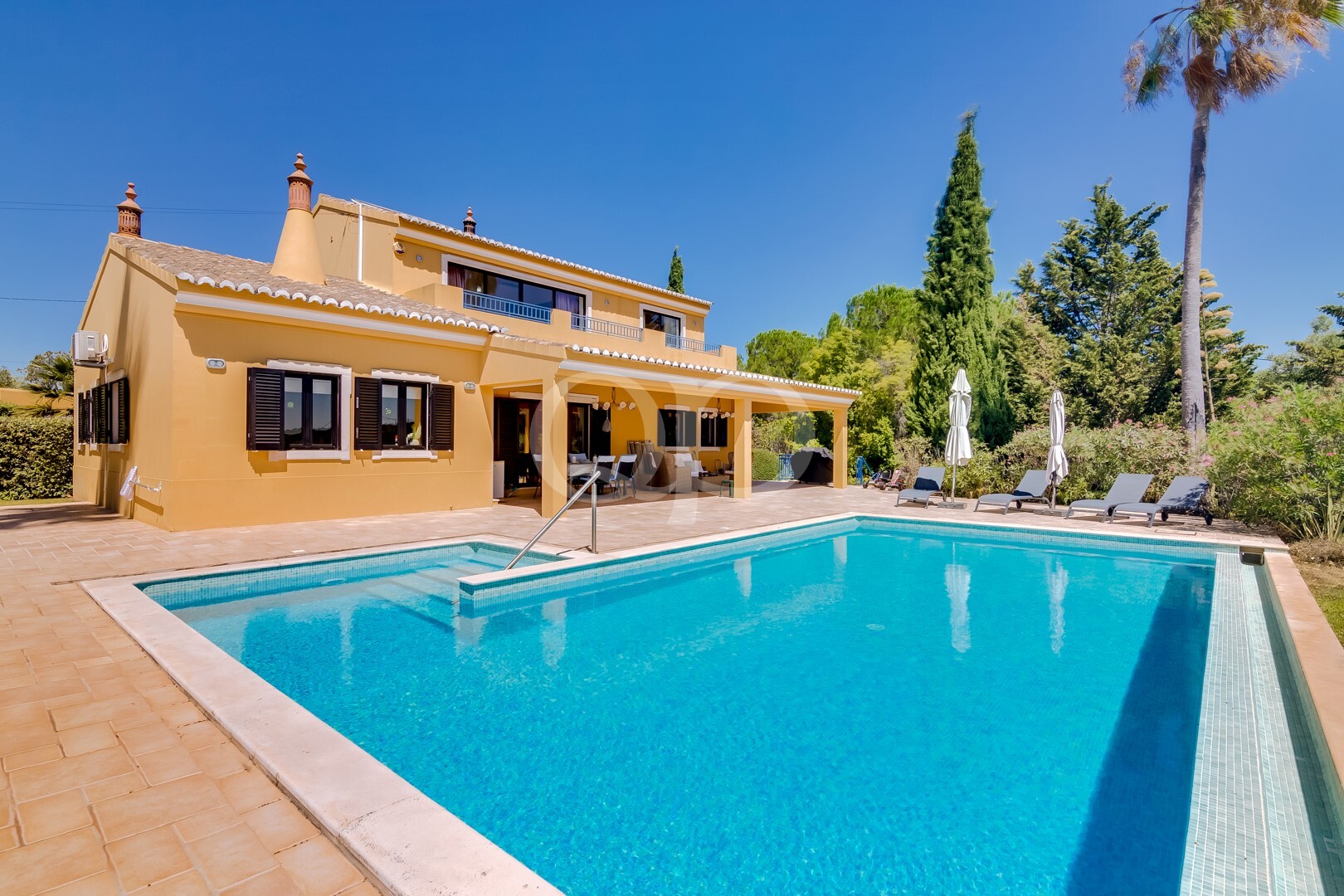 Charming Mediterranean villa with expansive dazzling pool and lush gardens