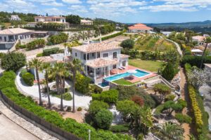 Aerial view of villa with swimming pool and landscaped grounds
