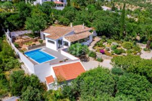 Aerial view of country villa with private pool and landscaped gardens