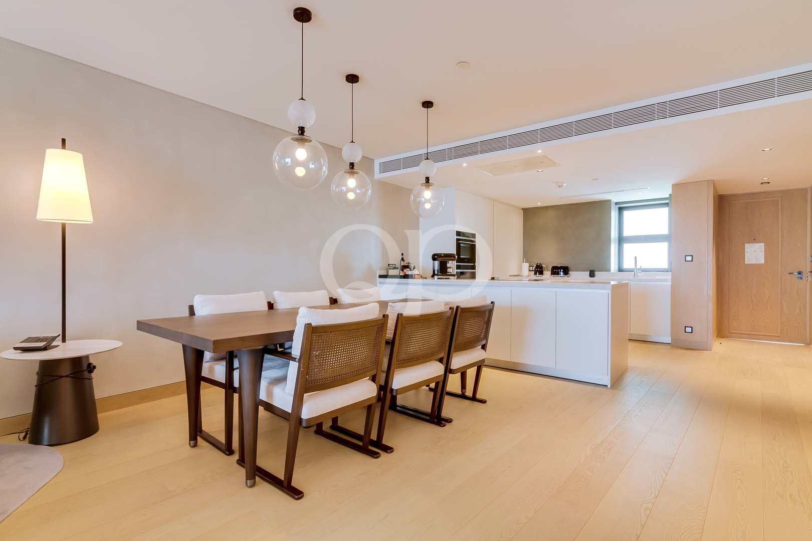 Open plan dining area with contemporary kitchen and pendant lighting