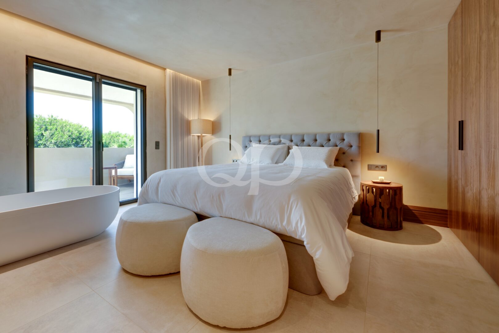Spacious bedroom with terrace access, contemporary furnishings and neutral finishes