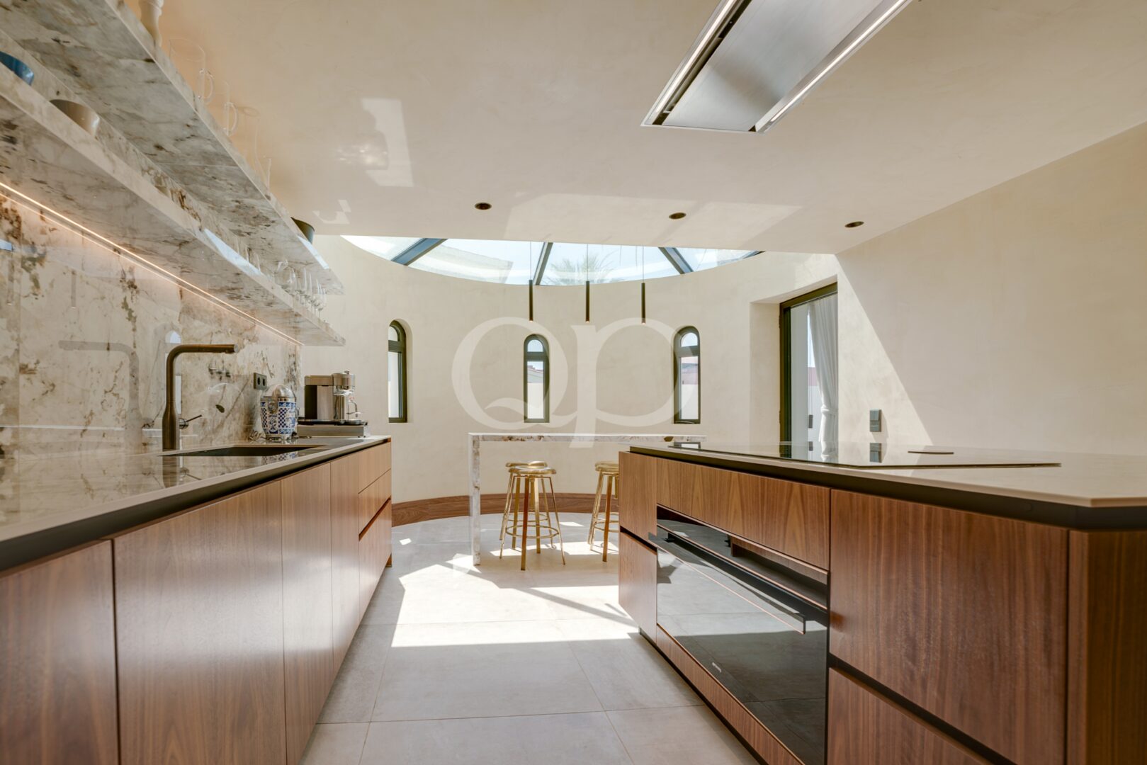 Open plan kitchen with marble finishes, skylight and central island