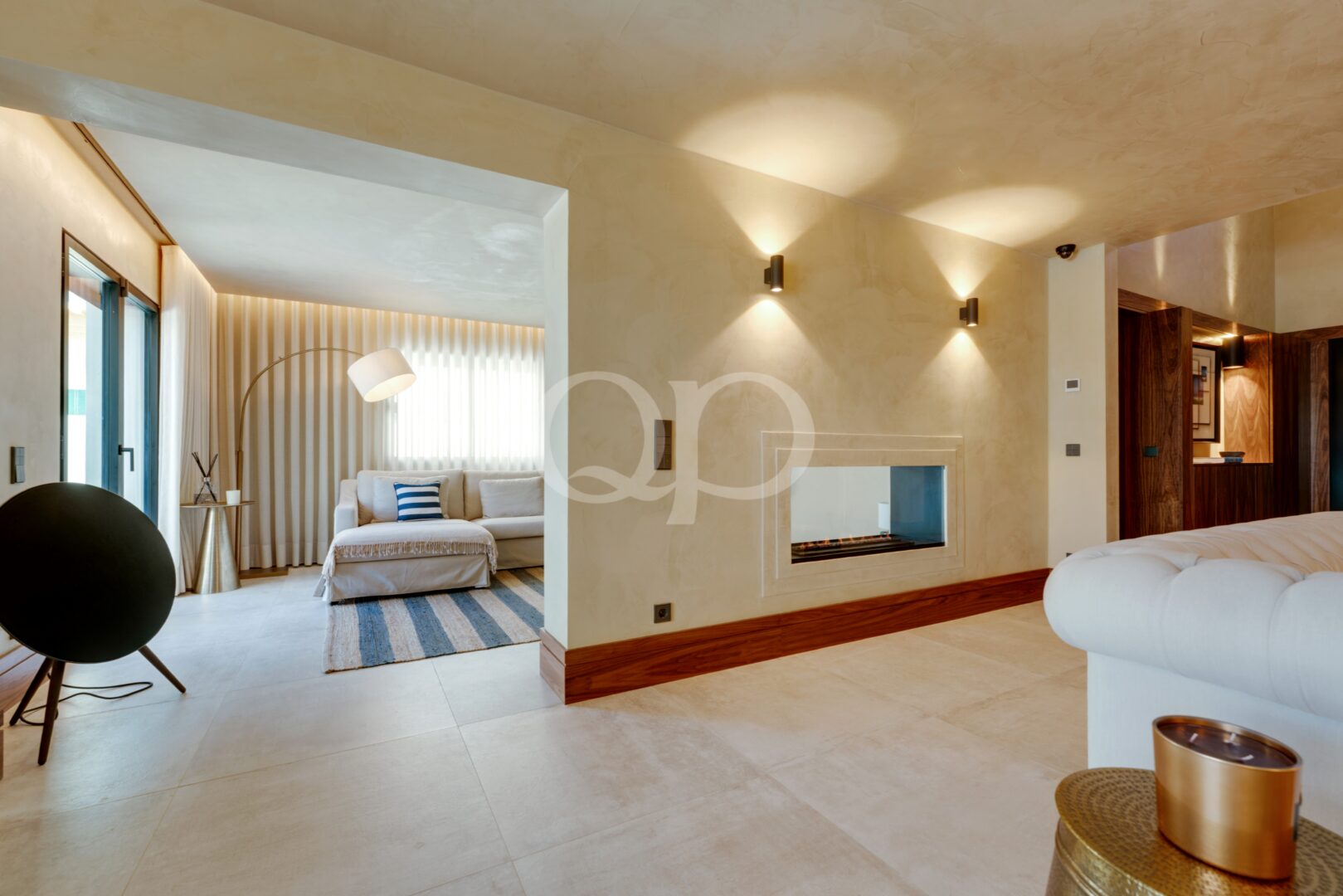 Bright bedroom suite with integrated fireplace and adjoining sitting area