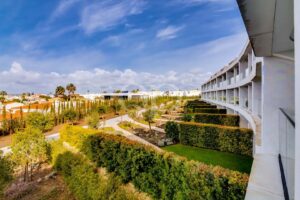 Landscaped resort gardens with pathways and contemporary residential buildings