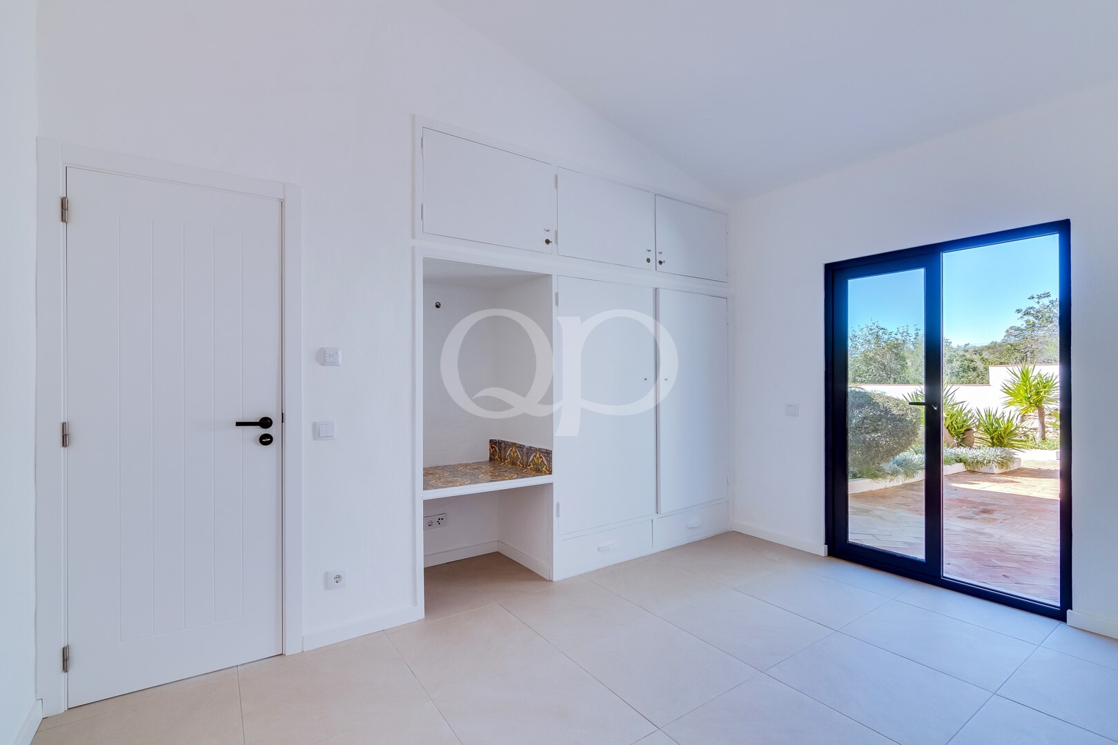 Bedroom with fitted wardrobes, integrated storage and direct outdoor access