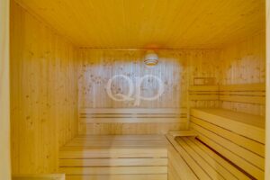 Sauna privé en bois avec bancs intégrés et éclairage contemporain