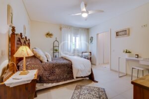 Chambre lumineuse et chaleureuse, avec un mobilier en bois, un éclairage tamisé et une décoration sobre et élégante