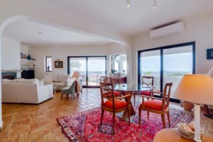 Stunning open plan dining and living area with a gorgeous fireplace and panoramic countryside and sea views