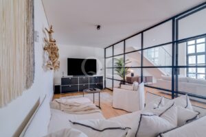 Sitting room with glass partition and staircase