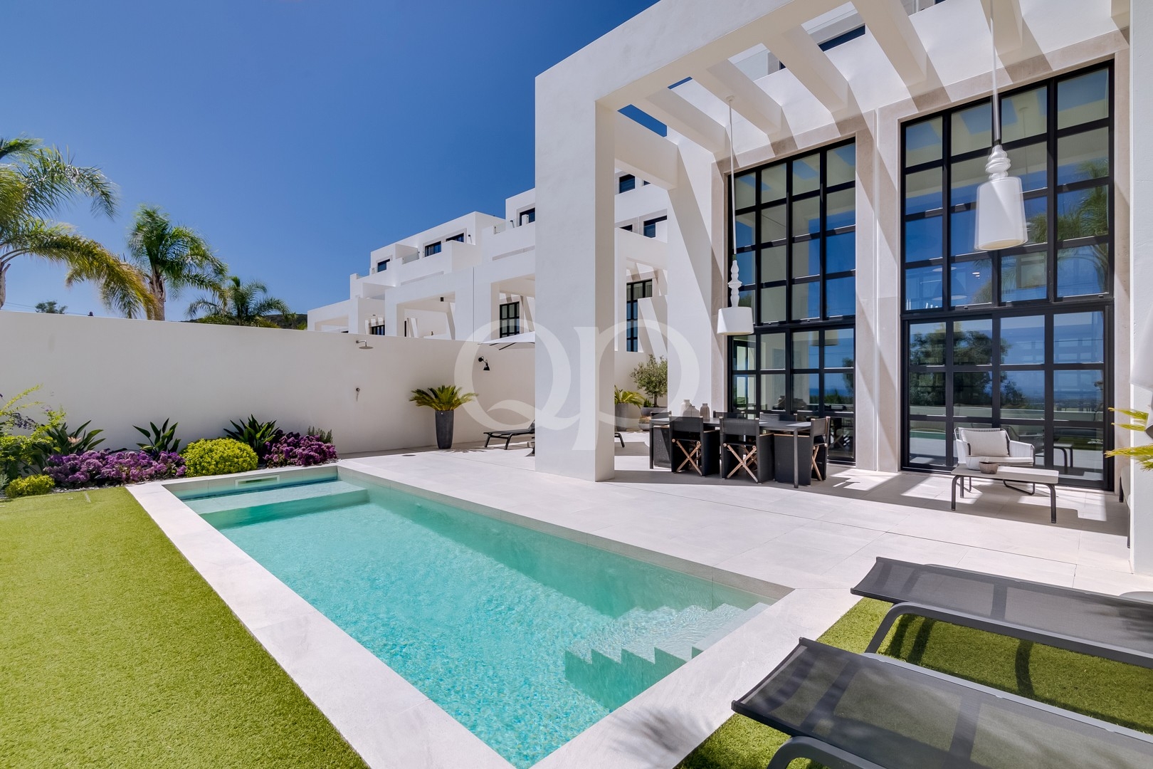 Villa exterior with private swimming pool and floor to ceiling windows