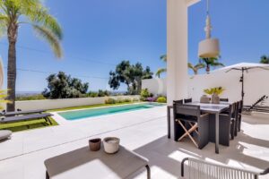 Pool terrace with outdoor dining area and open views