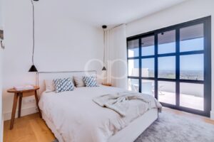 Bedroom with floor to ceiling windows and terrace access