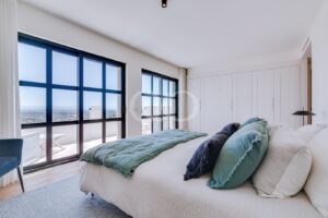 Bedroom with floor to ceiling windows and terrace access