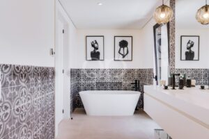 Bathroom with freestanding bathtub and patterned wall tiles