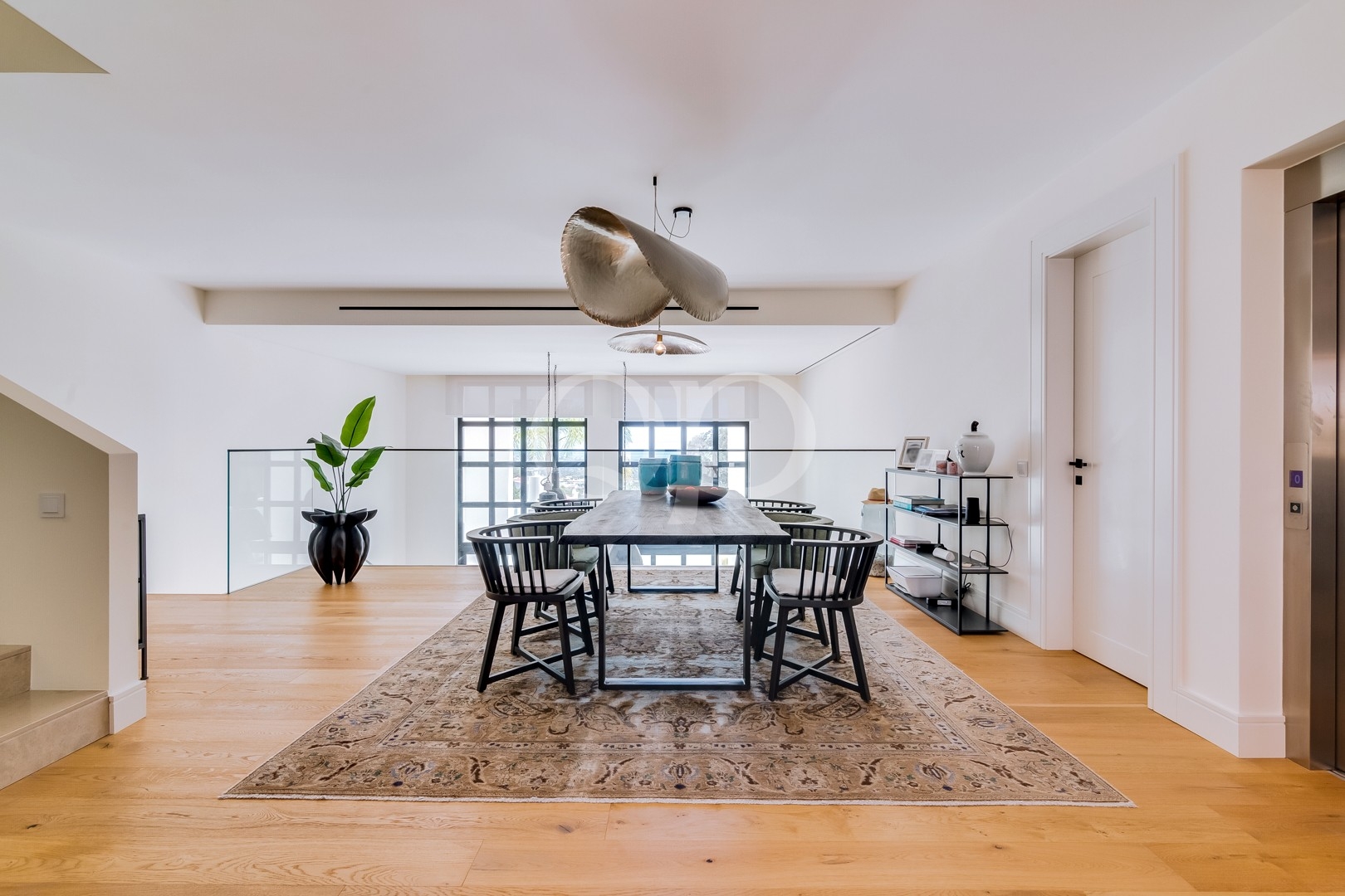 Dining room with large windows and contemporary pendant lighting