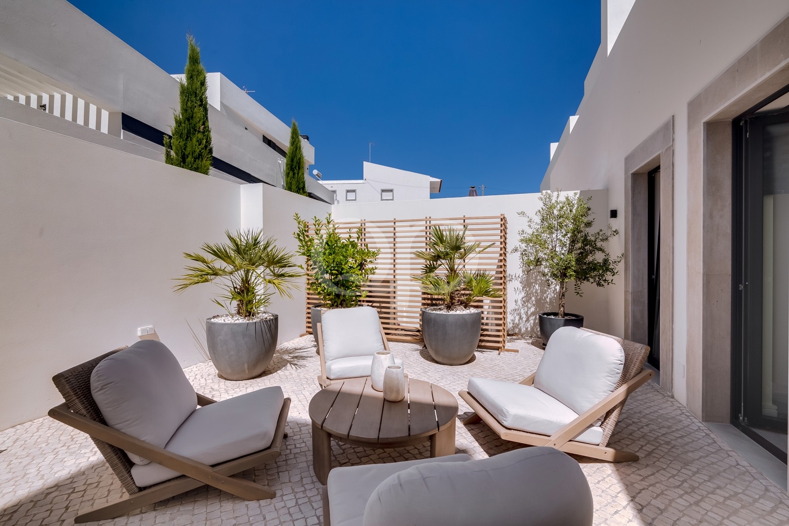Private terrace with outdoor seating and potted plants