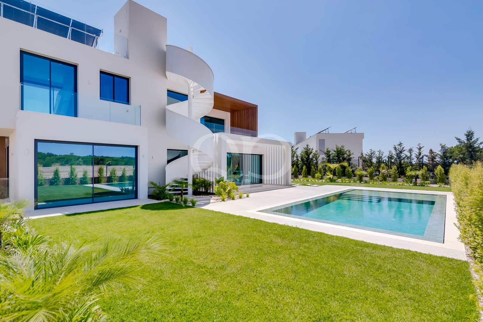 Extérieur de la villa avec piscine et pelouse aménagée