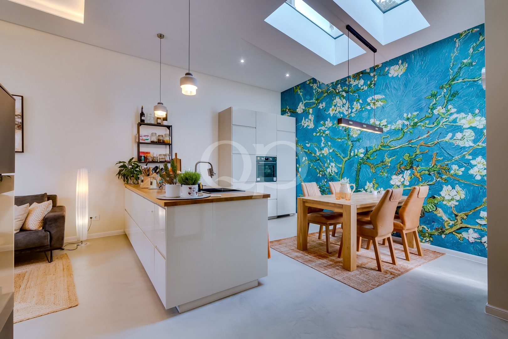 Contemporary open plan kitchen and dining room with wooden countertops and bright skylight
