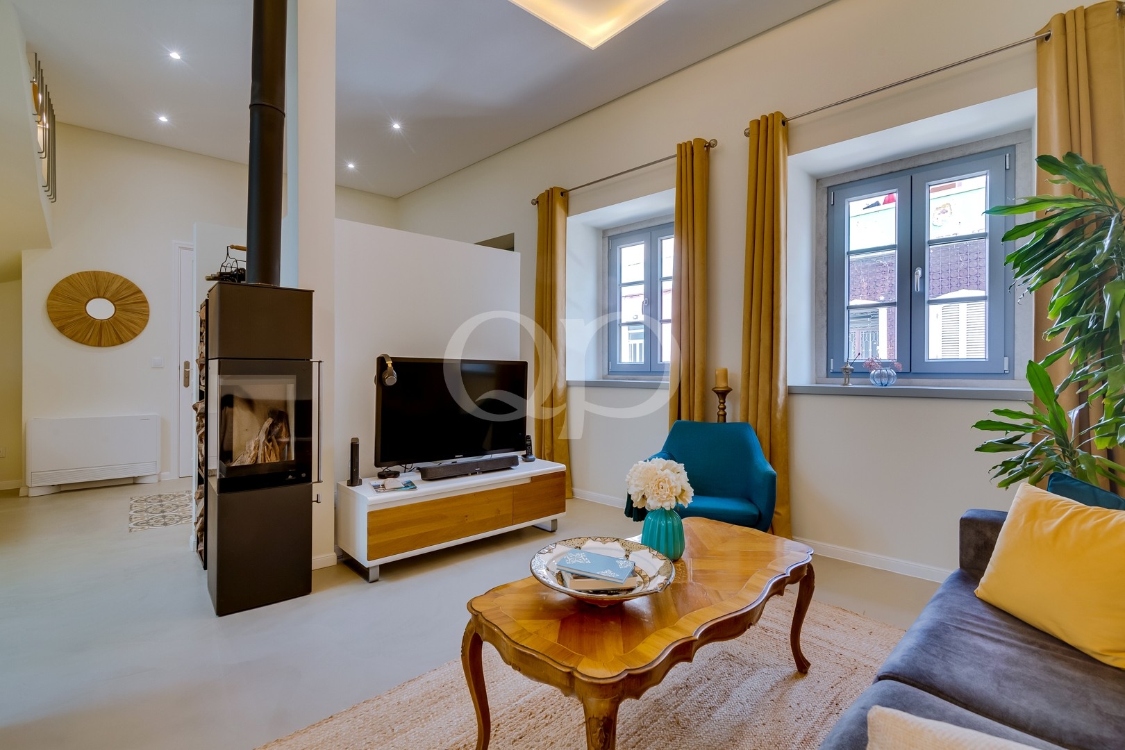 Stylish open plan living room with modern fireplace and abundant natural light