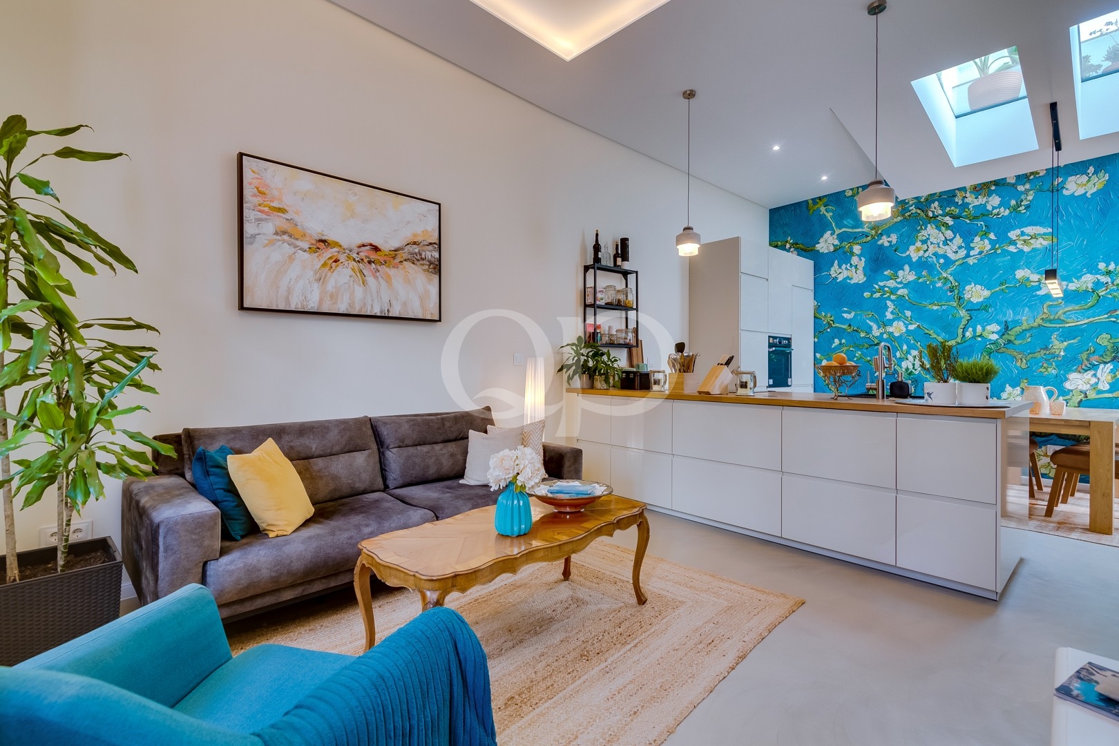 Stylish open-plan living space featuring a contemporary kitchen, vibrant décor, and abundant natural light
