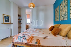 Bright, inviting bedroom featuring vibrant accents, elegant décor, and a spacious, comfortable layout