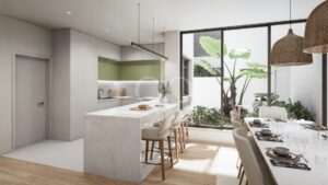 Cuisine avec îlot central, comptoir pour le petit-déjeuner et vue sur le jardin